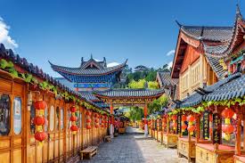A bustling street scene in a historic Chinese town with traditional architecture and red lanterns.