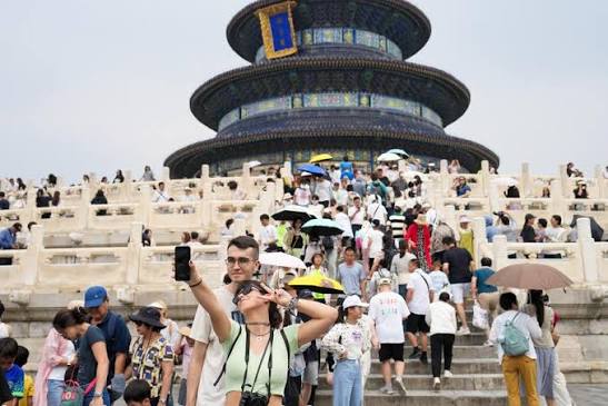 Tourists taking photos at the Temple of Heaven in Beijing, China